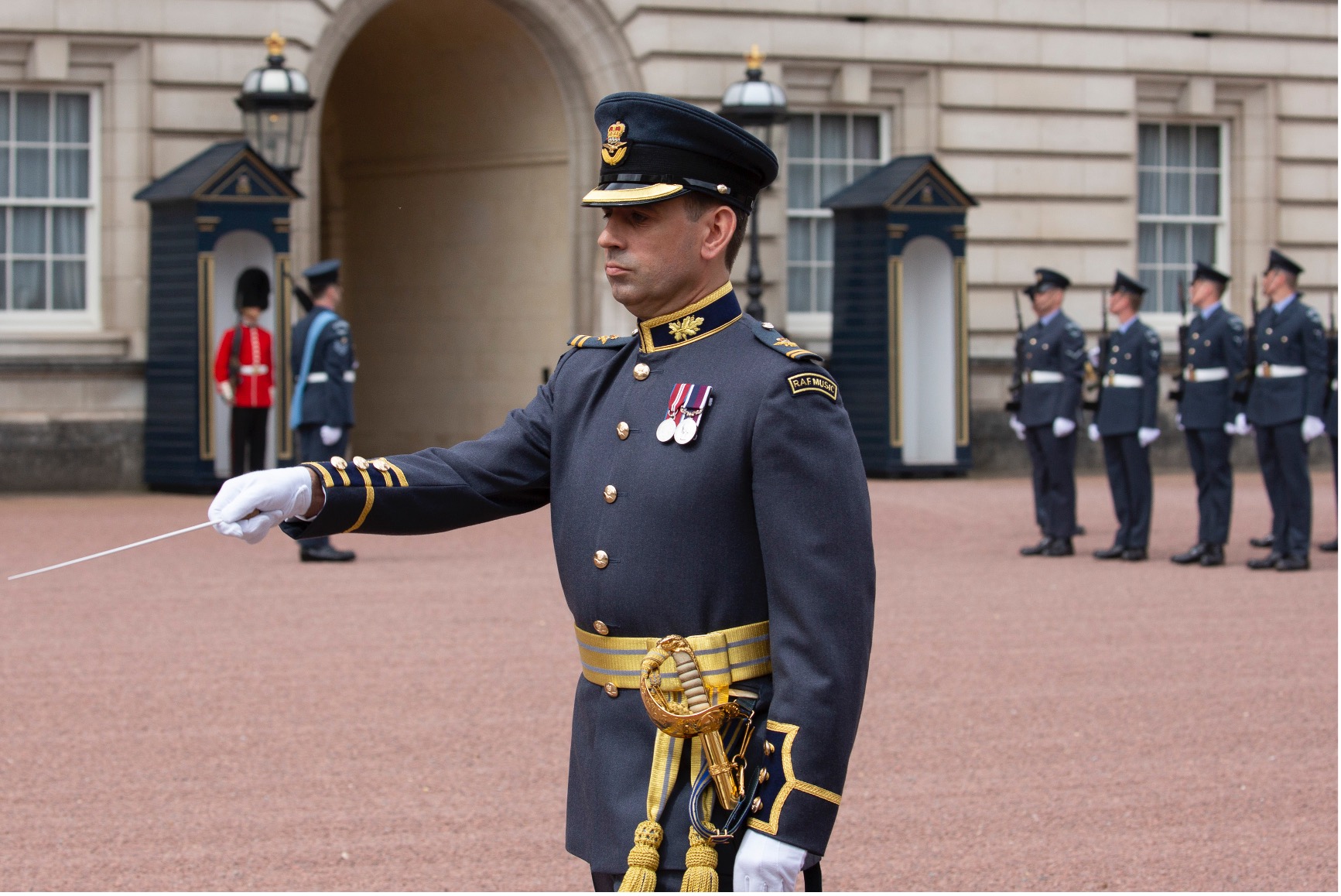 Musician marching outside Buckingham Palace.